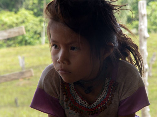 A young girl with long hair and a necklace.