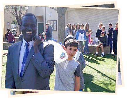 A man and boy in suits standing next to each other.