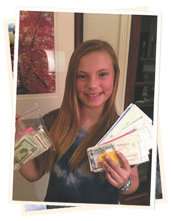A girl holding up several different types of tickets.