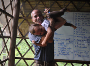 A man holding a child in his arms.
