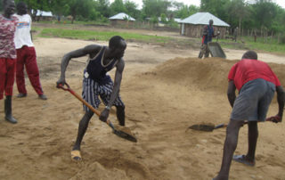 A group of men playing baseball on dirt field.