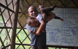 A man holding a child in his arms.