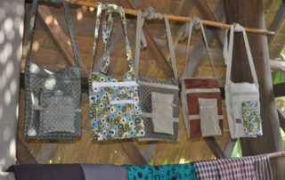 A row of bags hanging on the wall.