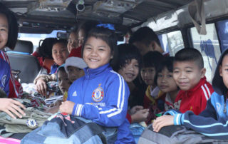 A group of children sitting in the back of an suv.