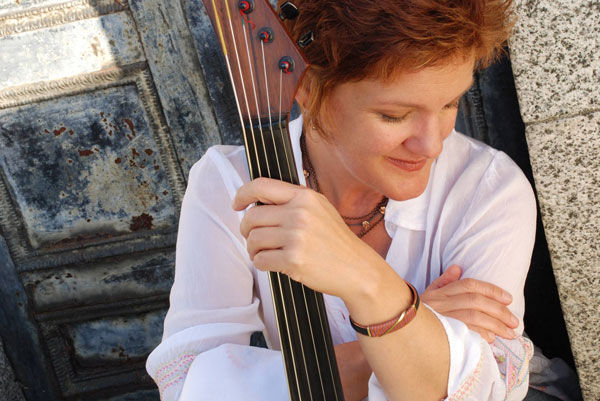 A woman holding a large instrument in her hands.