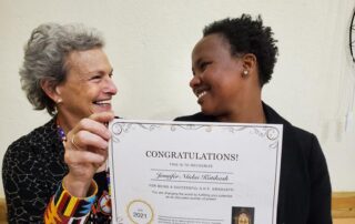 Two women holding a congratulations certificate