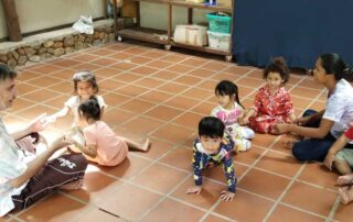 A group of children sitting on the floor