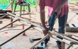 A person using a power tool to build a structure.